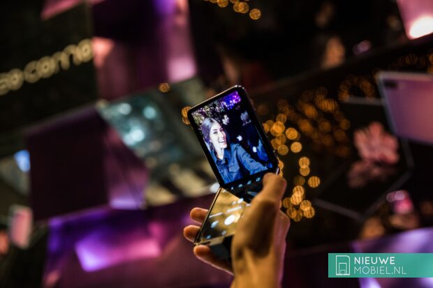 Woman holding the Galaxy Z Flip in her hands during the Fashion Week in Milan